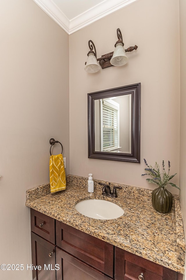 bathroom with vanity and ornamental molding