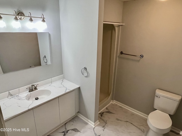 bathroom featuring vanity, a shower, and toilet