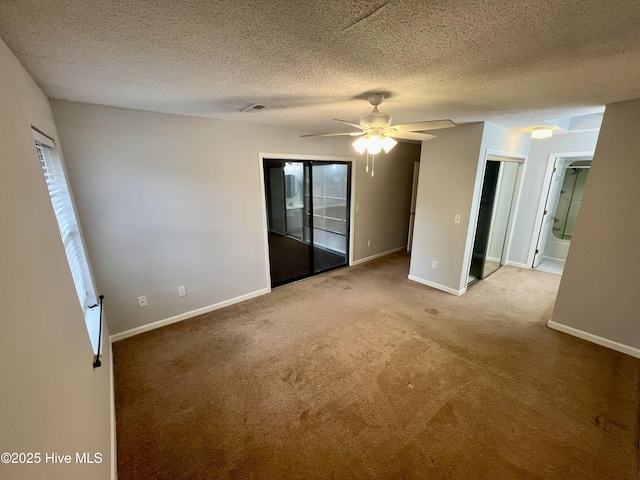 carpeted empty room with a textured ceiling and ceiling fan