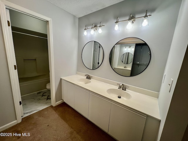 full bathroom featuring shower / tub combination, vanity, a textured ceiling, and toilet