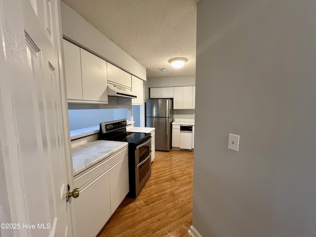 kitchen featuring a textured ceiling, light hardwood / wood-style floors, white cabinets, and appliances with stainless steel finishes