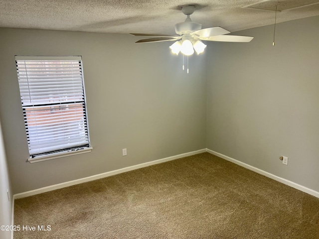 carpeted spare room with ceiling fan and a textured ceiling