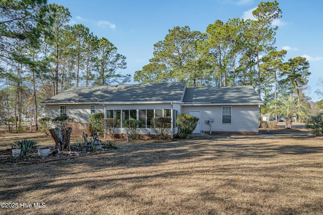 rear view of house with a yard