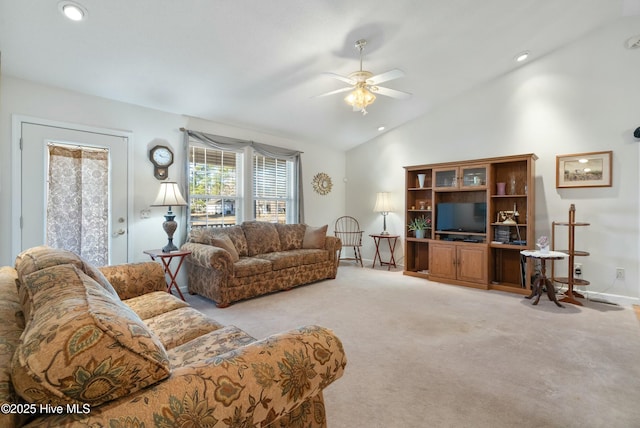 living room with high vaulted ceiling, light colored carpet, and ceiling fan