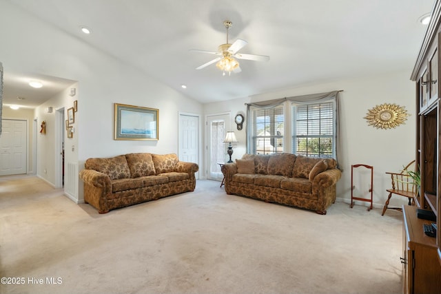 carpeted living room with vaulted ceiling and ceiling fan