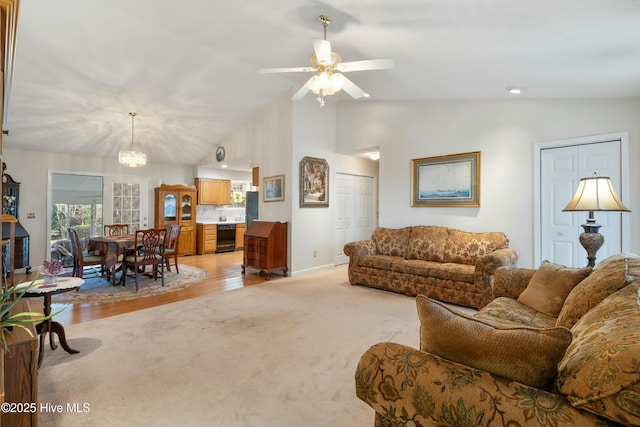 living room with lofted ceiling, light colored carpet, and ceiling fan