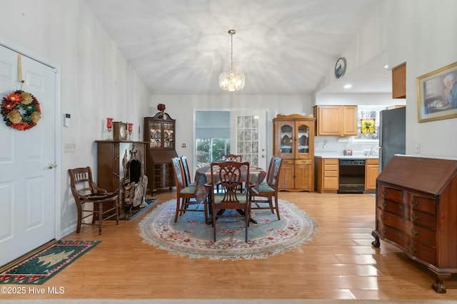 dining space with an inviting chandelier and light hardwood / wood-style flooring