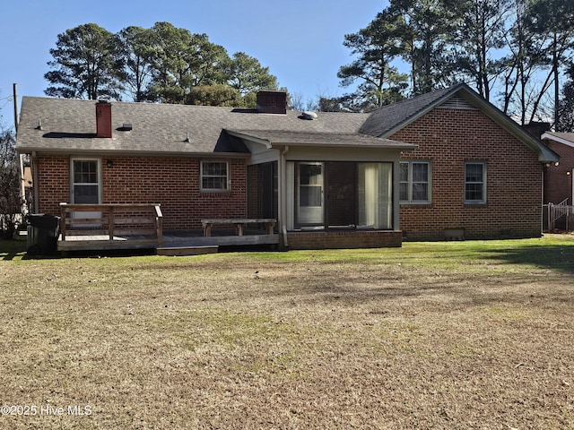 back of house with a yard, a deck, and a sunroom