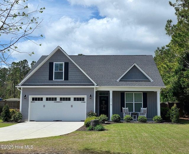 332 Grandview Dr, Hampstead, NC 28443 - view of front facade with a front yard, concrete driveway, fence, board and batten siding, and a porch