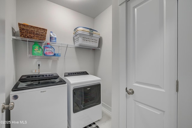 clothes washing area with washer and clothes dryer