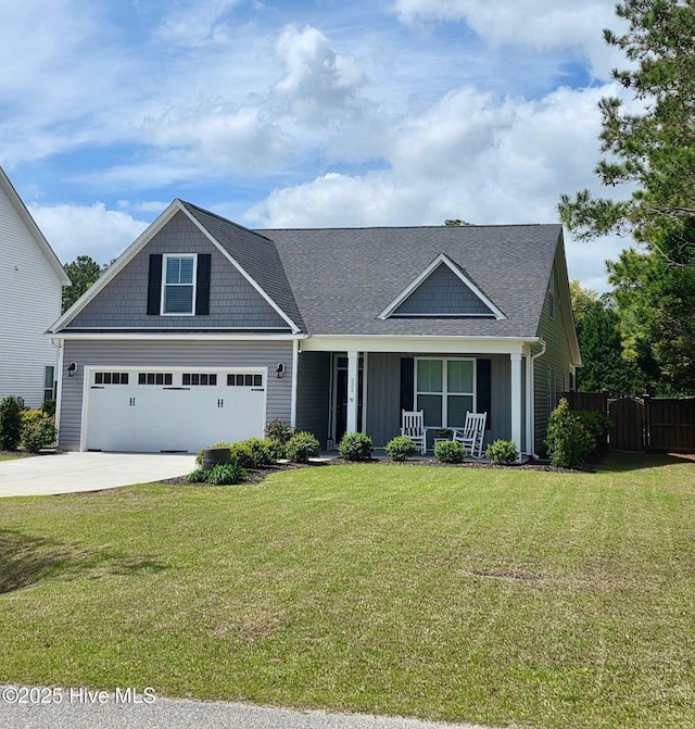 332 Grandview Dr, Hampstead, NC 28443 - craftsman-style house featuring fence, driveway, a front yard, covered porch, and a garage