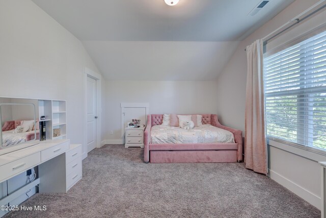 carpeted bedroom featuring multiple windows and lofted ceiling