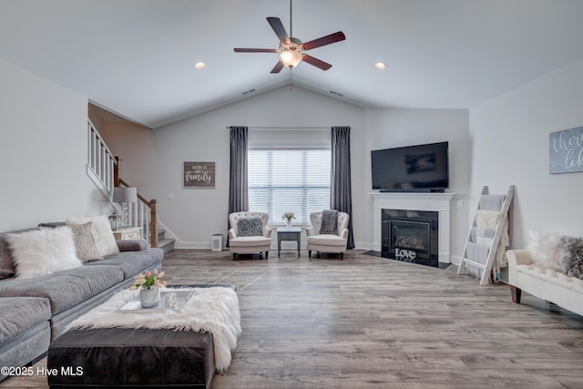 332 Grandview Dr, Hampstead, NC 28443 - living area featuring stairway, lofted ceiling, a fireplace with flush hearth, a ceiling fan, and wood finished floors