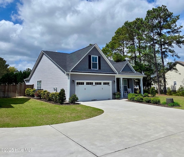 332 Grandview Dr, Hampstead, NC 28443 - view of front of home featuring driveway, a garage, fence, and a front lawn