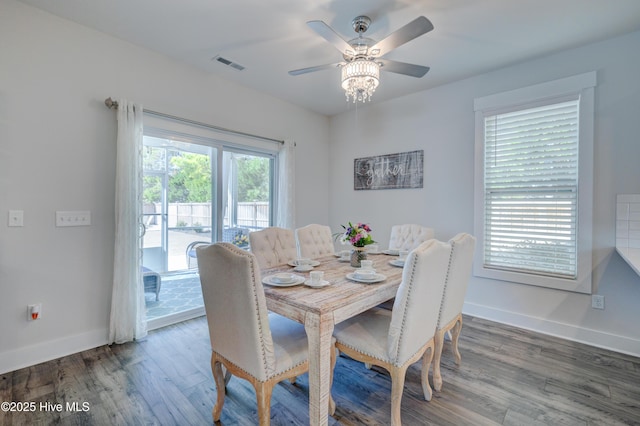 dining space with ceiling fan and dark hardwood / wood-style flooring