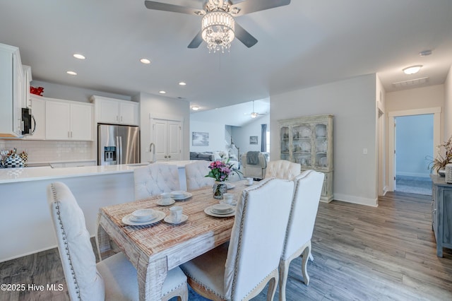 dining area featuring sink, ceiling fan, and light wood-type flooring