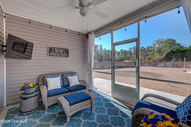 sunroom featuring ceiling fan