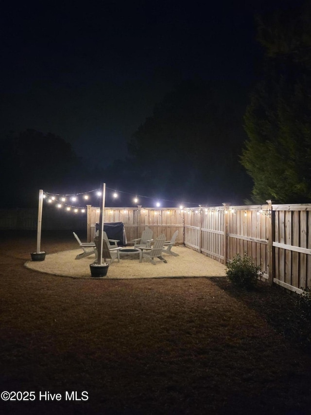 yard at twilight with an outdoor fire pit