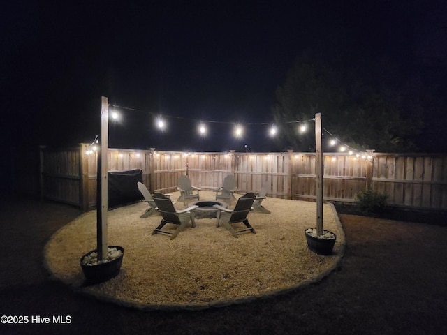 yard at twilight featuring an outdoor fire pit