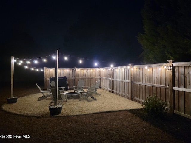 yard at twilight with an outdoor fire pit