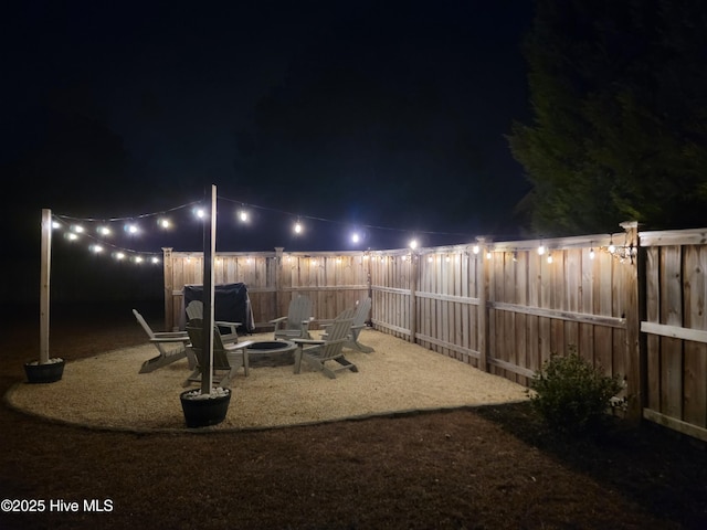 332 Grandview Dr, Hampstead, NC 28443 - yard at night with a fire pit and a fenced backyard