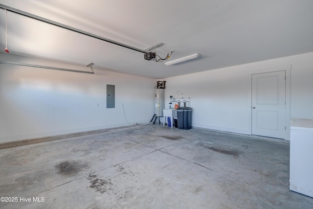 garage with a garage door opener, electric panel, and water heater