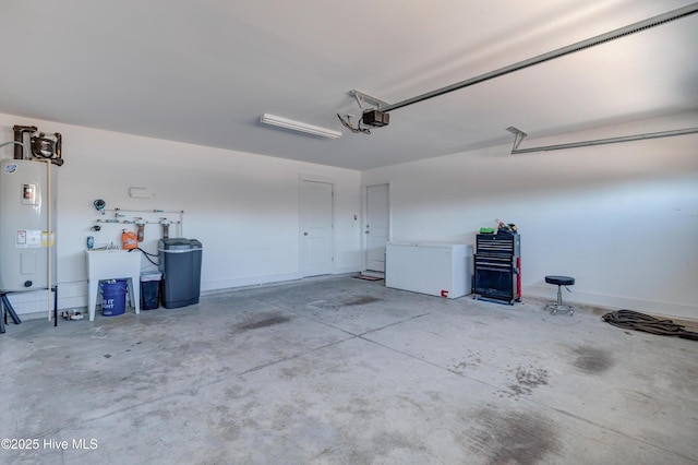 garage with a garage door opener and electric water heater