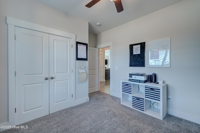 bedroom featuring light colored carpet, ceiling fan, and a closet