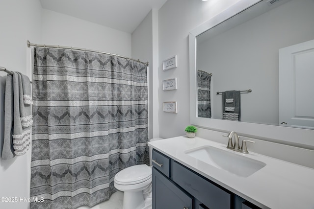 bathroom featuring walk in shower, vanity, and toilet