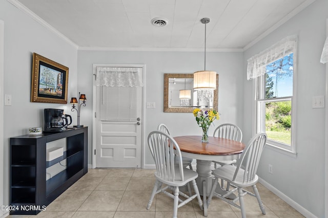 dining area featuring light tile patterned floors and crown molding