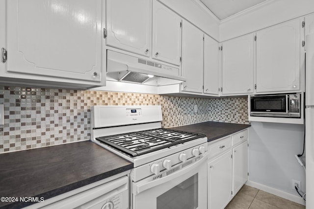 kitchen with light tile patterned floors, ornamental molding, white appliances, decorative backsplash, and white cabinets