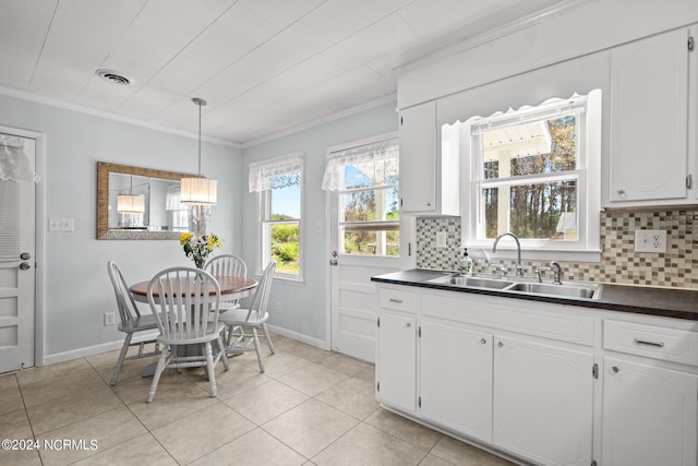 kitchen featuring white cabinetry, sink, and crown molding