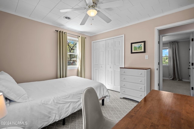 bedroom with multiple windows, crown molding, and light carpet