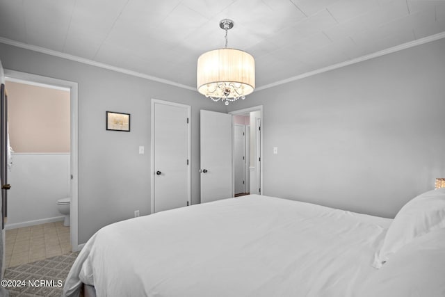 bedroom featuring crown molding, connected bathroom, and a chandelier