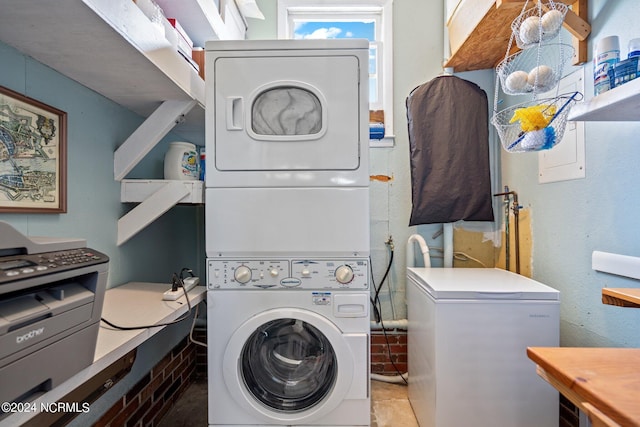 laundry area with stacked washer / drying machine