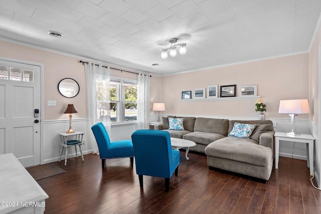 living room with ornamental molding and dark hardwood / wood-style flooring