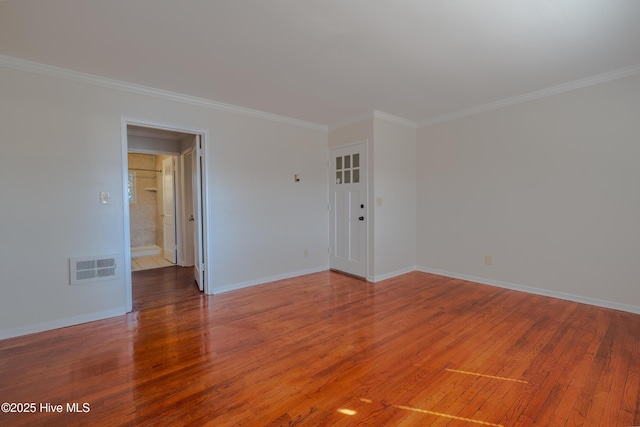 unfurnished room with crown molding and wood-type flooring