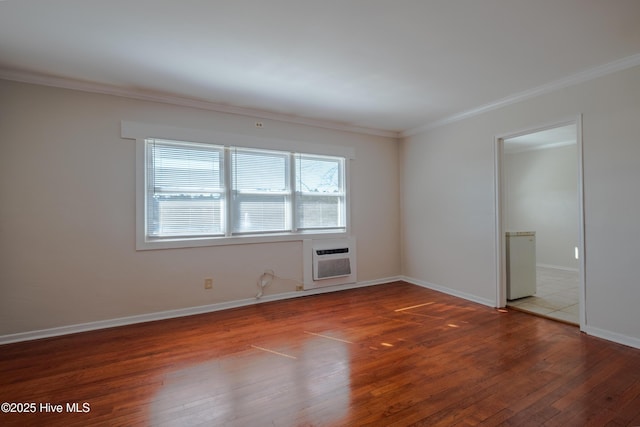 unfurnished room featuring a wealth of natural light, hardwood / wood-style floors, a wall mounted AC, and crown molding