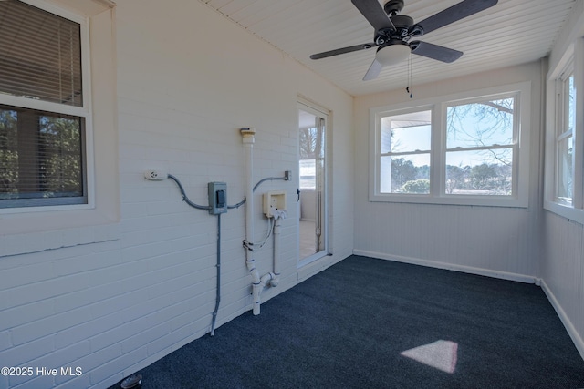 unfurnished sunroom with ceiling fan