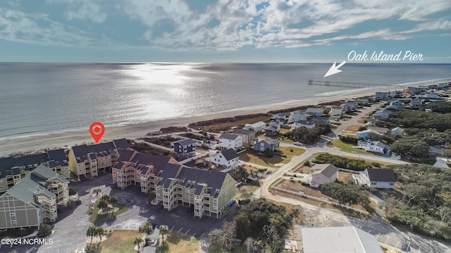 bird's eye view featuring a water view and a view of the beach