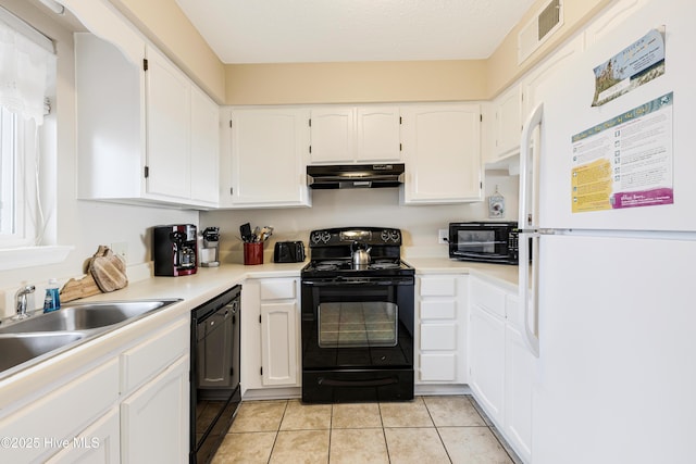 kitchen featuring sink, white cabinetry, a textured ceiling, light tile patterned floors, and black appliances