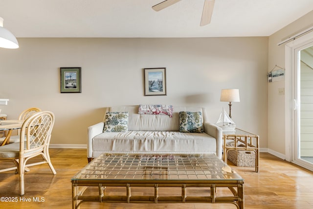 living room with hardwood / wood-style flooring and ceiling fan