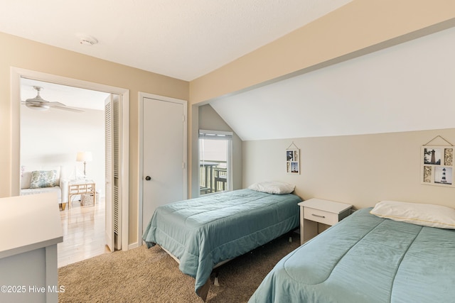 bedroom featuring light colored carpet and lofted ceiling