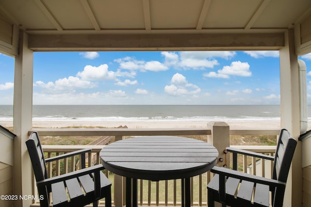 balcony with a water view and a beach view