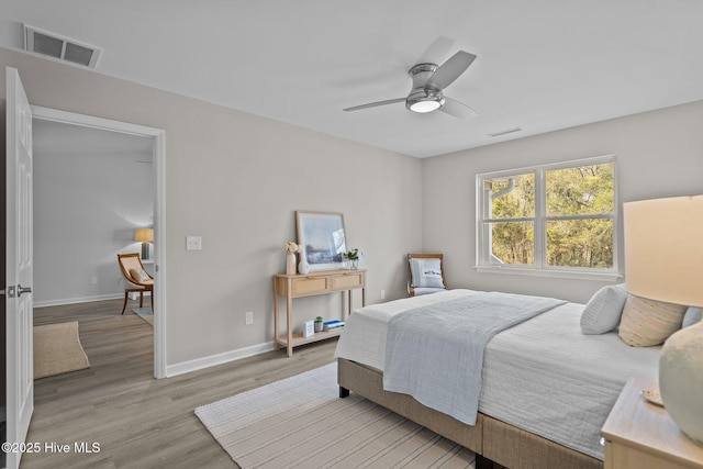 bedroom with ceiling fan and light hardwood / wood-style flooring