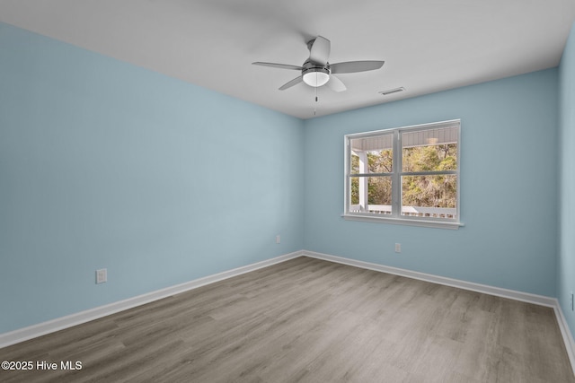 spare room with ceiling fan and light hardwood / wood-style flooring