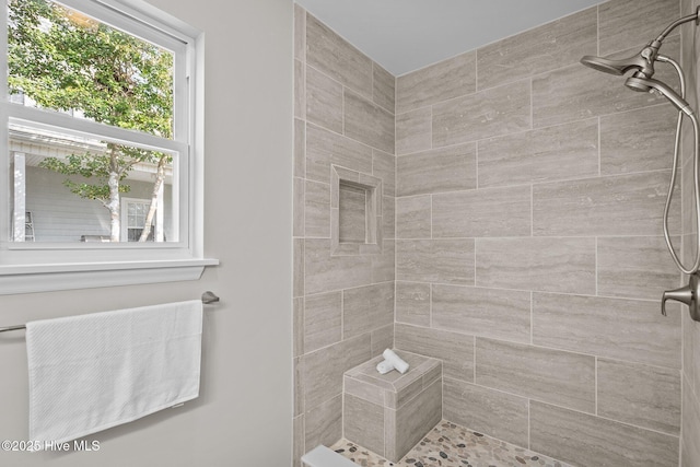 bathroom featuring tiled shower