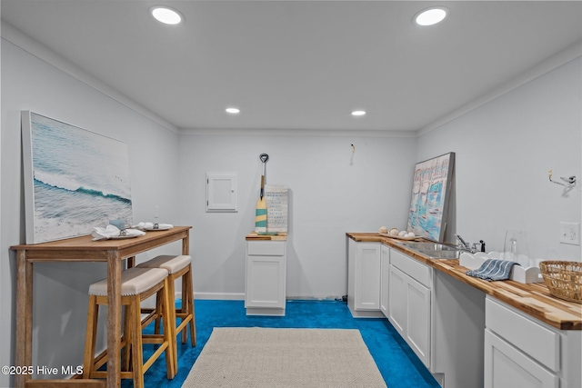 interior space featuring sink and dark colored carpet