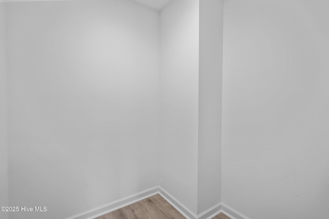 unfurnished room with wood-type flooring