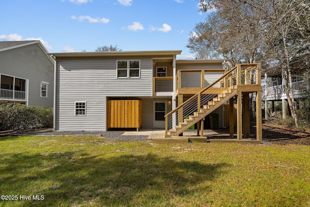 back of house featuring a deck and a lawn